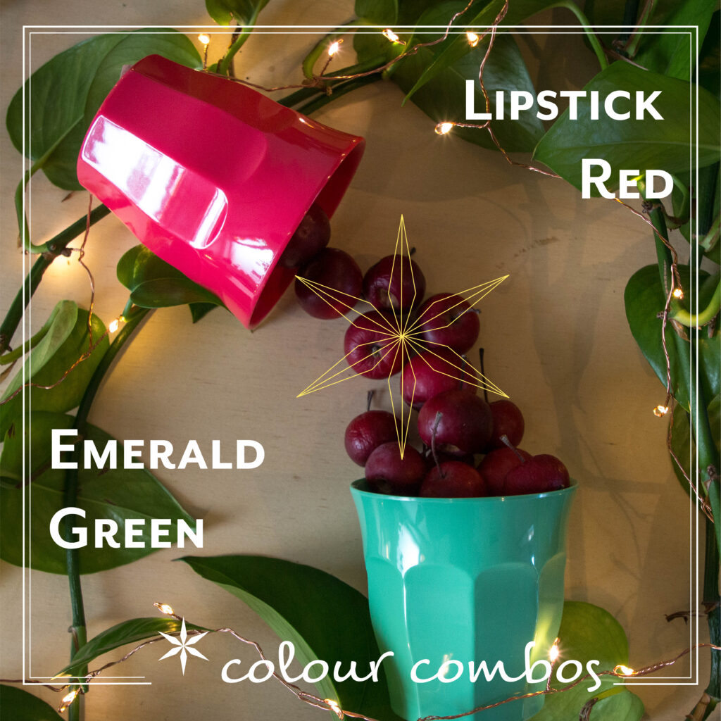 Crab apples are featured falling from a red cup to a green cup against a background of twinkly fairylights and soft green leaves.